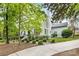 Beautifully landscaped yard with a charming brick home, featuring a manicured lawn and mature trees at 310 Whitestone Rd, Charlotte, NC 28270