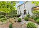 Inviting home exterior with a well-maintained lawn, lush greenery, and a charming walkway leading to the entrance at 310 Whitestone Rd, Charlotte, NC 28270