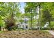 Charming two-story brick home with a well-manicured lawn and mature trees, creating a serene and inviting atmosphere at 310 Whitestone Rd, Charlotte, NC 28270