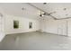 Large garage with bright white walls, windows and multiple access doors at 310 Whitestone Rd, Charlotte, NC 28270