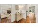 Hallway view with hardwood floors, stylish console table, and a glimpse into the living room, creating a warm ambiance at 310 Whitestone Rd, Charlotte, NC 28270