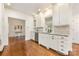Well-lit kitchen features white cabinets, granite countertops, hardwood floors, and stainless steel appliances at 310 Whitestone Rd, Charlotte, NC 28270