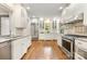 Bright kitchen offers white cabinets, stainless steel appliances, and hardwood floors for a modern look at 310 Whitestone Rd, Charlotte, NC 28270