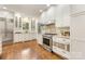 Modern kitchen boasts white cabinets, stainless steel appliances, and hardwood floors for stylish cooking at 310 Whitestone Rd, Charlotte, NC 28270