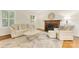 Elegant living room featuring a fireplace, hardwood floors, and stylish neutral furniture, perfect for relaxation and entertaining at 310 Whitestone Rd, Charlotte, NC 28270