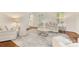 Cozy living room with neutral-toned furnishings, hardwood floors, and a large area rug, creating a comfortable space at 310 Whitestone Rd, Charlotte, NC 28270