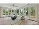 Bright sun room with brick floor, neutral furnishings and large windows overlooking the back yard at 310 Whitestone Rd, Charlotte, NC 28270