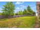 Expansive backyard featuring a wooden fence, ample green space, and mature trees at 3327 Flagler Cir, Midland, NC 28107