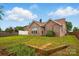 Lush backyard of a brick home, featuring a wooden fence and a well-maintained lawn at 3327 Flagler Cir, Midland, NC 28107