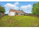 Well-kept backyard showing the brick exterior and a white fence, providing a private outdoor space at 3327 Flagler Cir, Midland, NC 28107