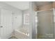 Well-lit bathroom with a soaking tub, separate shower, and a window for natural light at 3327 Flagler Cir, Midland, NC 28107