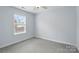Bright bedroom with a large window and neutral carpet, perfect for relaxation at 3327 Flagler Cir, Midland, NC 28107