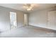 Spacious bedroom with neutral carpet, a ceiling fan, and ensuite bathroom access at 3327 Flagler Cir, Midland, NC 28107