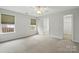 Spacious bedroom with two windows and plush carpet; ensuite bathroom and walk-in closet access add convenience at 3327 Flagler Cir, Midland, NC 28107
