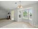 Bright dining area with large bay window, decorative lighting, and adjacent fireplace features tiled flooring at 3327 Flagler Cir, Midland, NC 28107