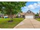 Brick home with green lawn, a two-car garage, and mature trees in a residential neighborhood at 3327 Flagler Cir, Midland, NC 28107