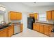 This practical kitchen is equipped with wooden cabinets, a stainless dishwasher, and sleek black appliances at 3327 Flagler Cir, Midland, NC 28107