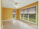 Bright sunroom with tile flooring, large windows, and a ceiling fan fixture at 3327 Flagler Cir, Midland, NC 28107