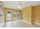 This sunroom has tile flooring, multiple windows for natural lighting and a ceiling fan at 3327 Flagler Cir, Midland, NC 28107