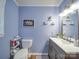 Functional bathroom with blue walls, updated fixtures, and ample storage space for toiletries at 335 Linda St, Salisbury, NC 28146