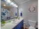 Inviting bathroom featuring a blue vanity, a sink, a mirror, a toilet, and a shower with blue floral curtain at 335 Linda St, Salisbury, NC 28146