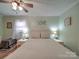 Light and airy bedroom featuring light green walls and a neutral-toned bed with matching lamps at 335 Linda St, Salisbury, NC 28146