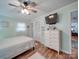 Comfortable bedroom featuring neutral walls, a ceiling fan, wood-look floors, and a walk-in closet at 335 Linda St, Salisbury, NC 28146