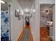 Inviting hallway with hardwood floors, neutral walls, and decorative pictures create a warm path through home at 335 Linda St, Salisbury, NC 28146