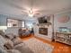 Cozy living room features a brick fireplace and hardwood flooring at 335 Linda St, Salisbury, NC 28146