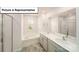 Well-lit bathroom featuring dual sinks, a soaking tub, and a glass-enclosed shower at 3412 Lacebark Ln, Gastonia, NC 28056