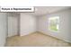Cozy bedroom with neutral carpeting and a window overlooking the lawn at 3412 Lacebark Ln, Gastonia, NC 28056