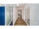 Inviting entryway featuring hardwood floors, a decorative glass door, and French doors at 3412 Lacebark Ln, Gastonia, NC 28056