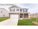 Charming two-story home featuring a stone facade, covered porch, and a well-manicured lawn at 3412 Lacebark Ln, Gastonia, NC 28056