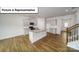 Modern kitchen with a large island, stainless steel appliances, and hardwood floors at 3412 Lacebark Ln, Gastonia, NC 28056