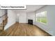Inviting living room featuring a fireplace, hardwood floors, and staircase at 3412 Lacebark Ln, Gastonia, NC 28056