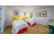 Well-lit ' bedroom featuring two twin beds with colorful bedding and decor at 3414 Lacebark Ln, Gastonia, NC 28056