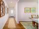 Welcoming hallway featuring wood floors, elegant wall decor, and an inviting view of the dining area at 3414 Lacebark Ln, Gastonia, NC 28056