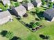 Aerial view of the fenced backyard, with mature trees, lawn, neighboring homes, and a patio at 3424 Windstone Ln, Gastonia, NC 28056