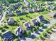 Aerial view of a neighborhood featuring well-maintained lawns, mature trees and two-story homes at 3424 Windstone Ln, Gastonia, NC 28056