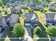 Aerial view of a neighborhood featuring mature trees, well-maintained lawns, and two-story homes at 3424 Windstone Ln, Gastonia, NC 28056