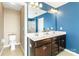 Modern bathroom features double sinks, a large mirror, and blue accent wall at 3424 Windstone Ln, Gastonia, NC 28056
