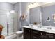 Bathroom features a double sink vanity, framed mirror, and glass enclosed shower at 3424 Windstone Ln, Gastonia, NC 28056