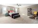 Spacious bedroom features a bed with dark wooden frame, plush carpet and ceiling fan at 3424 Windstone Ln, Gastonia, NC 28056