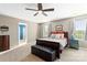 Bedroom with wooden bed frame, black storage bench and adjacent bathroom entrance at 3424 Windstone Ln, Gastonia, NC 28056