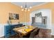 Well-lit dining room featuring a unique table, stylish light fixture, and a convenient built-in mudroom area at 3424 Windstone Ln, Gastonia, NC 28056