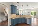 Open kitchen design features granite counters, stainless appliances and blue cabinets at 3424 Windstone Ln, Gastonia, NC 28056