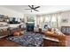 Spacious living room with fireplace, large windows and ceiling fan at 3424 Windstone Ln, Gastonia, NC 28056