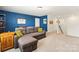 Spacious room featuring blue accent wall and gray sofa with decorative pillows at 3424 Windstone Ln, Gastonia, NC 28056
