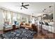 Open living room and kitchen area with hardwood floors and lots of natural light at 3424 Windstone Ln, Gastonia, NC 28056