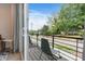 Balcony view featuring a cozy sitting area with chairs overlooking a quiet residential street lined with trees at 355 S Bruns Ave, Charlotte, NC 28208